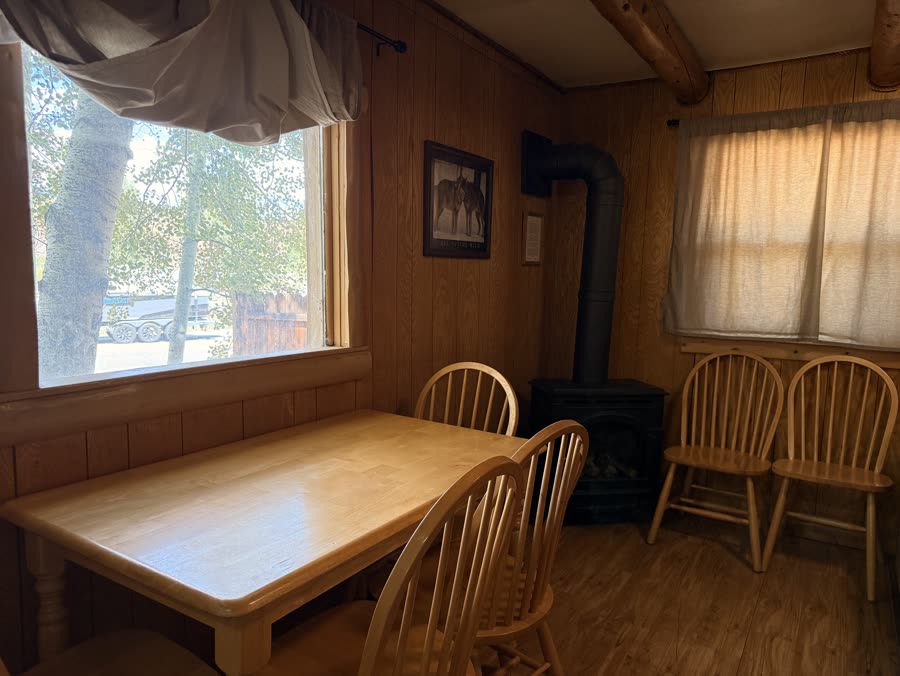 Cabin dining table beside a wood stove