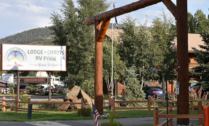The timber entrance arch and sign at Ute Bluff Lodge on Highway 160