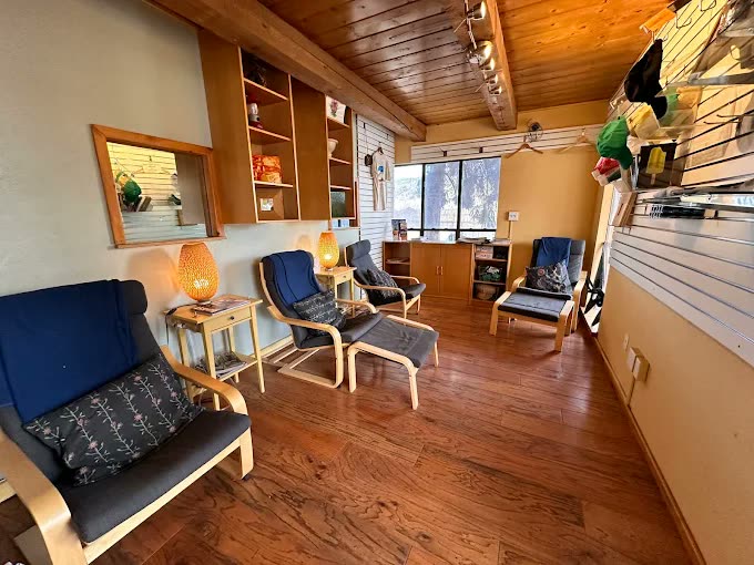 Bright common room with armchairs and windows onto the trees
